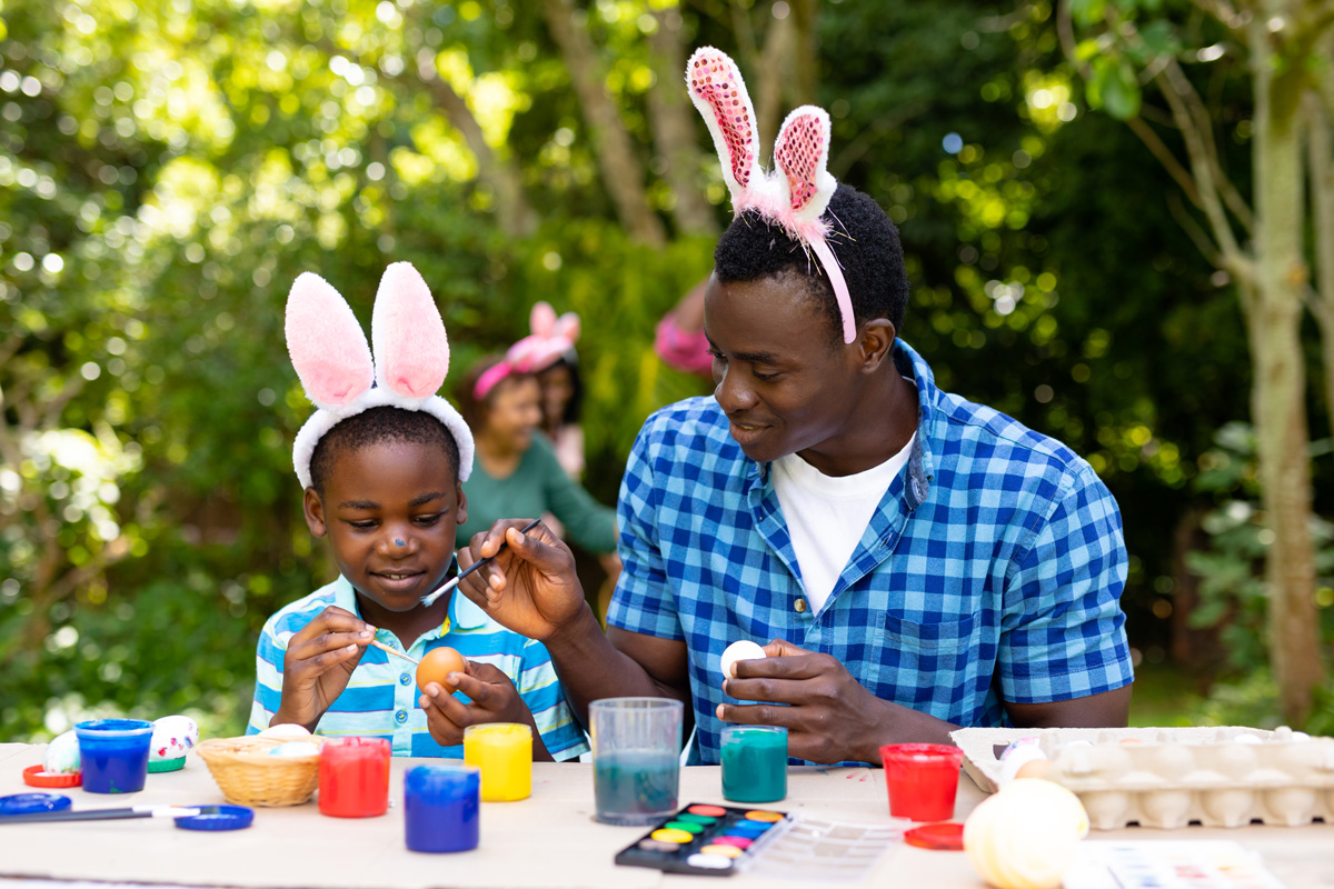 Father Painting Eggs with Son for Easter